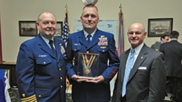 Rescue swimmer Willard Milam, flanked by Coast Guard Commandant Thad Allen (left) and AFRAS chairman Terry Cross, was given the Gold Medal for saving the crew of a fishing vessel.