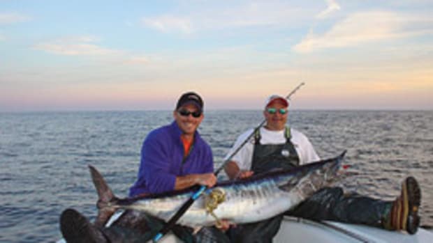 Palomba (left) and Bursten show off a 110-pound wahoo caught with light tackle.