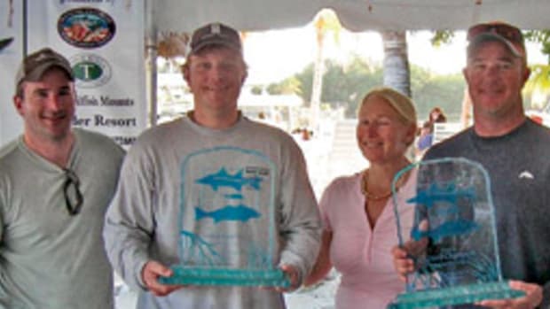 Left to right are, Mike Criscola, tournament chairman; Baker Bishop, grand champion; Charlotte Ambrogio, tournament director; and Captain Drew Moret.