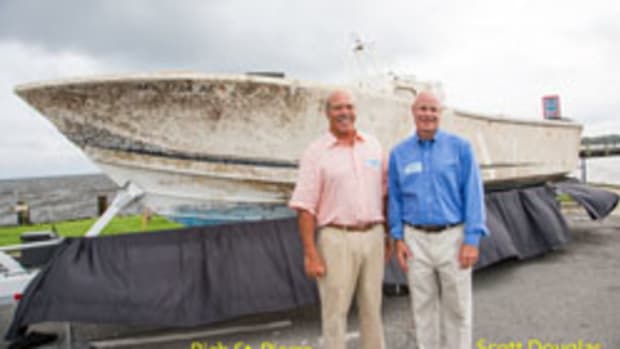 Queen Bee’s owner, Scott Douglas (right), and his brother-in-law, Rich St. Pierre, were recently reunited with the boat they were knocked out of.