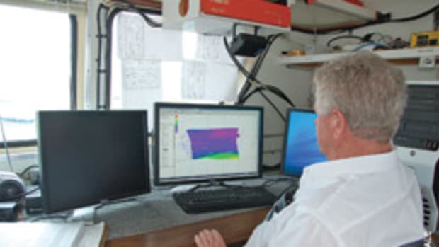 Army Corp of Engineers surveyor Tommy Thomas attends to business in his office aboard the survey vessel Florida.