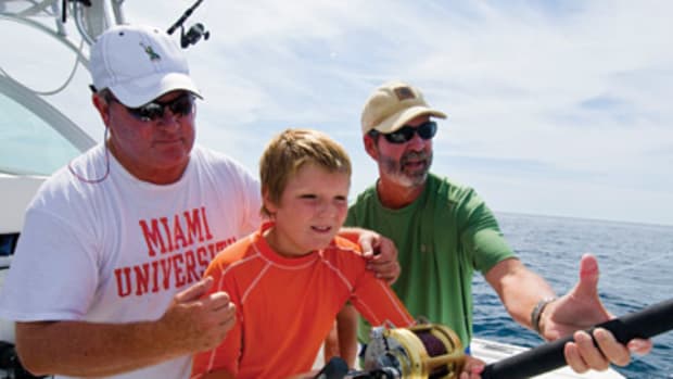 Ted O'Connor (left) and Soundings editor Bill Sisson steady Bill's son, Michael, 11, as he fights his first shark.