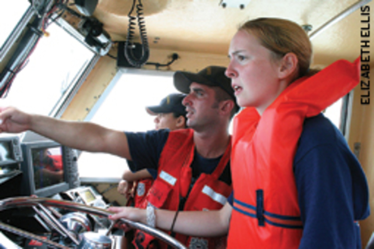Sea Scout Rachel Sampson gets some navigation tips from Coast Guardsman Matthew Vail during a safety session held at the biennial Koch Cup Regatta.