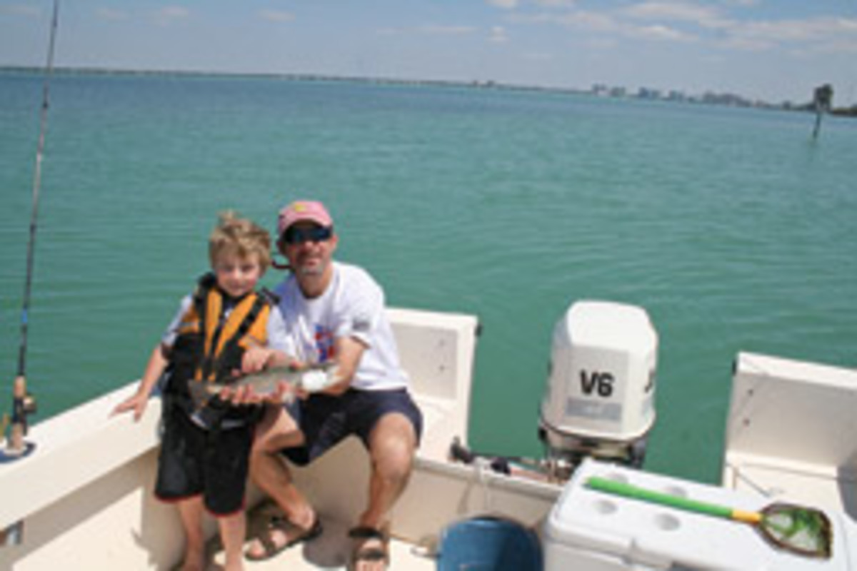 The author's son Jake and husband, Darrell, fishing near Sarasota, Florida, on their Parker.