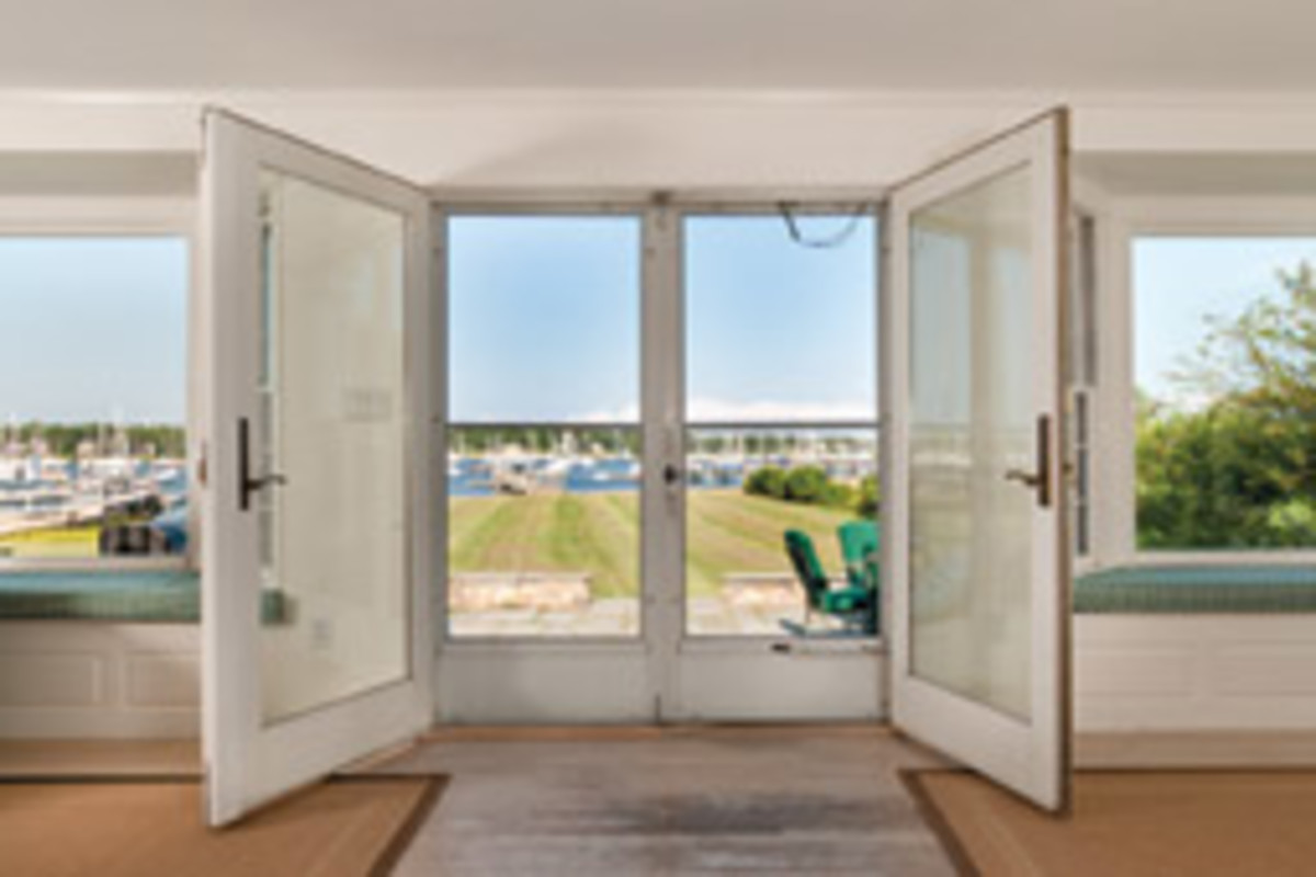 Atrium doors and bay windows offer views of Sippican Harbor.