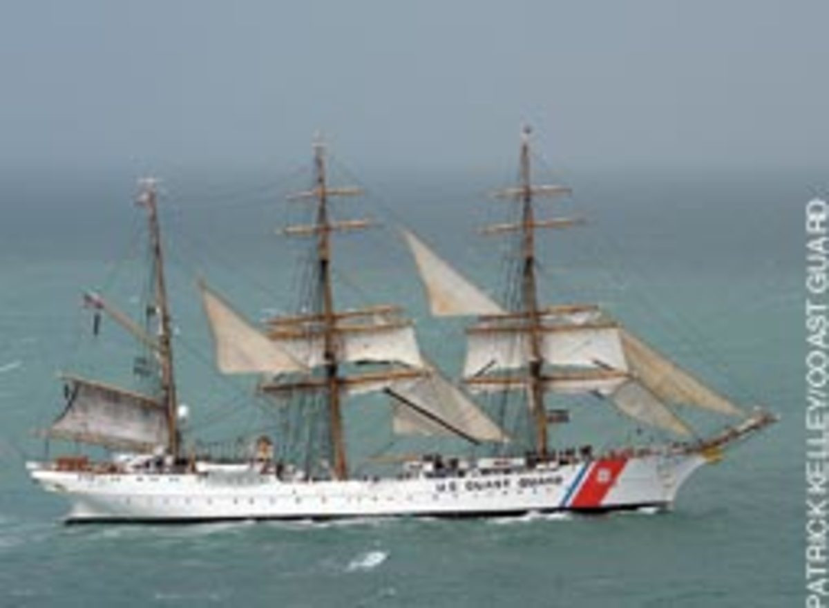 The crew aboard Coast Guard cutter Eagle, far from its New London, Conn., home port work to take in the sails July 2 as the ship heads to Corpus Christi, Texas. Crewmen work in the rigging nearly 100 feet above the water.