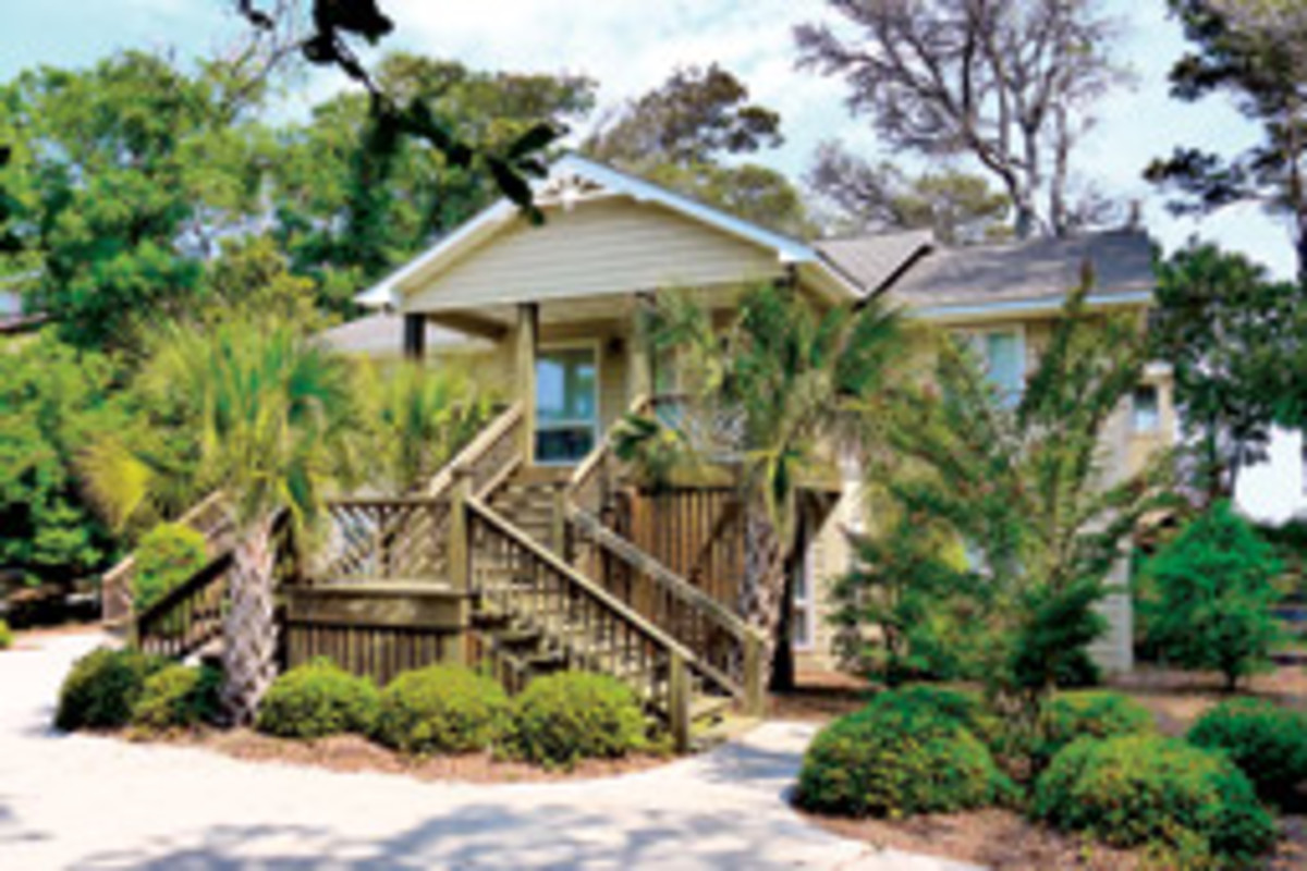 This home on Bogue Sound sits amid shade trees, yet is less than a mile from the ocean sands in Atlantic Beach, N.C.