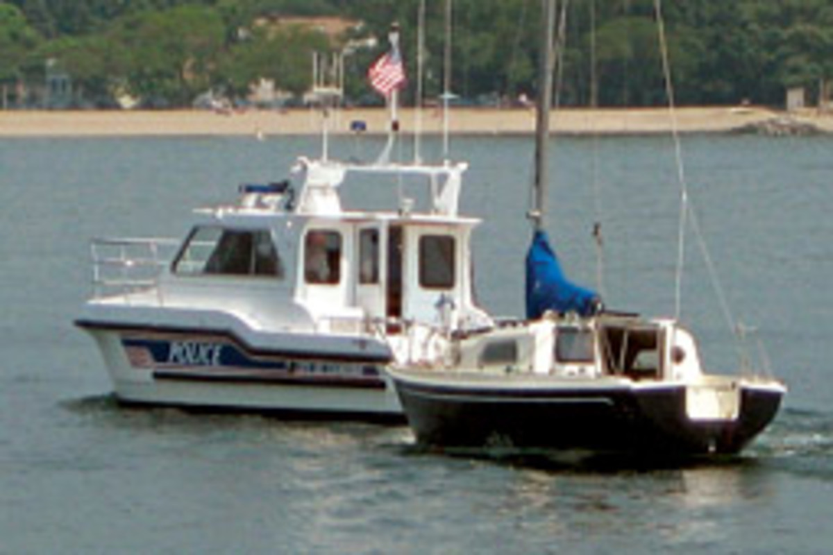 Once raised, the boat was towed away by authorities.