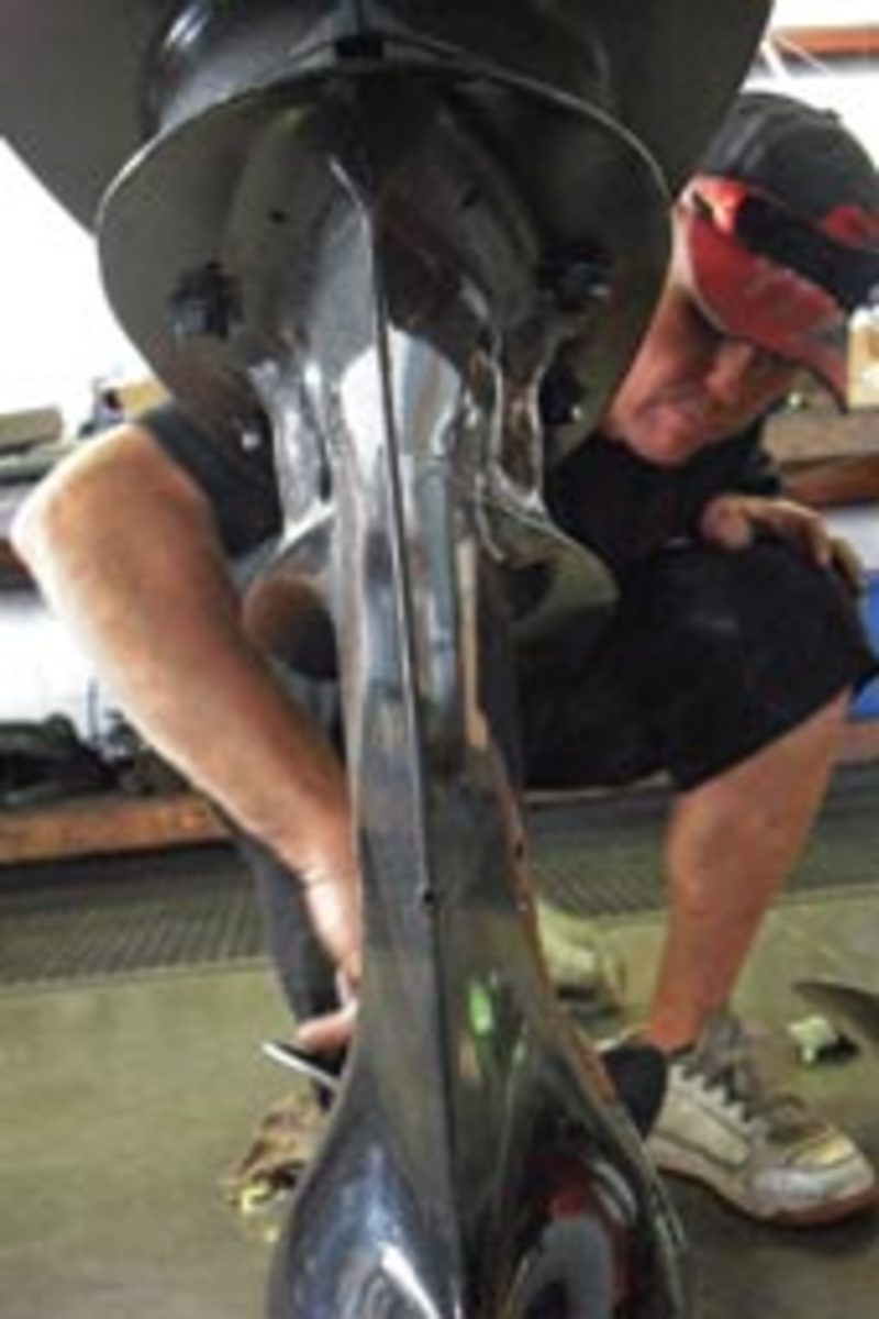Josh Coleman, a technician at H2O Marine, slides a three-bladed wheel on the DF250.