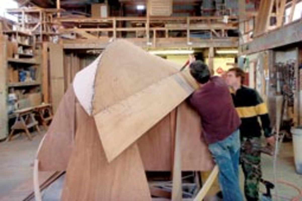 Builders stitch the hull of a 33-foot Devlin lobster yacht.