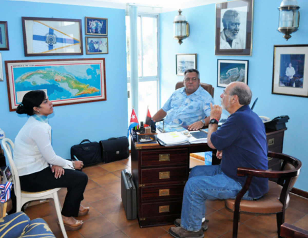 Bruce Kessler, organizer of the West Coast FUBAR powerboat rally, discusses the possibility of a similar rally to Cuba with Jose Escrich, commodore of the Hemingway International Yacht Club in Havana, and his translator.
