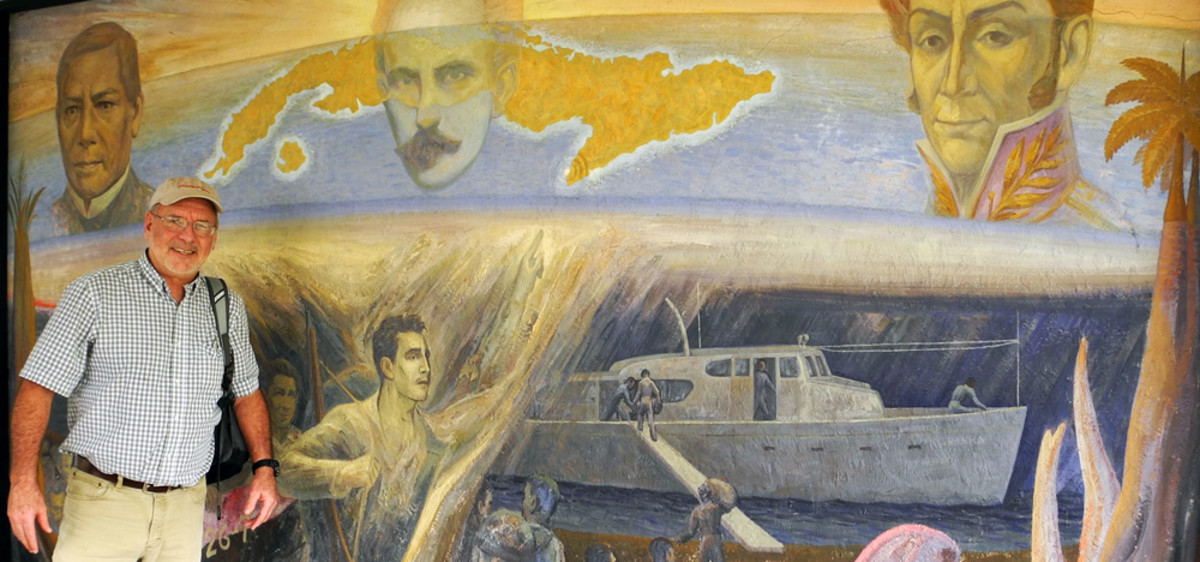 The author poses in front of a mural in Tuxpan on Mexico’s Gulf Coast, which shows Granma being provisioned for the invasion of Cuba. Tuxpan was the departure point for Raul Castro’s historic 1956 expedition. Among the 82 men on board was Che Guevara and Castro himself.
