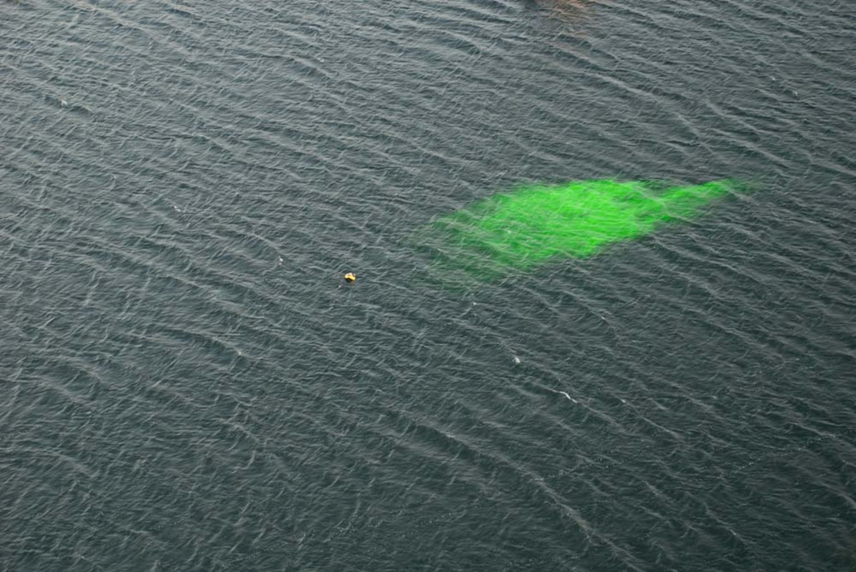 A sea dye marker creates an expansive, bright target near a person in the water. Vincent Daniello photo