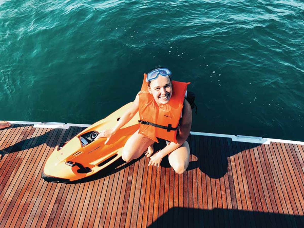 Krista Karlson launches a SeaBob 
underwater scooter from the swim platform