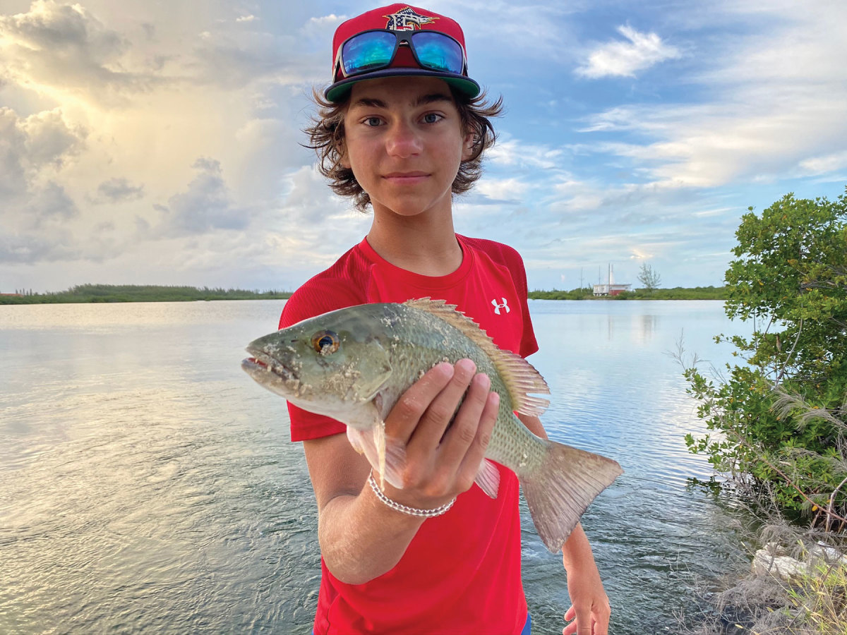 LeAnn Pliske’s son shows off his catch during some socially distanced fun with the whole family in Bimini. 