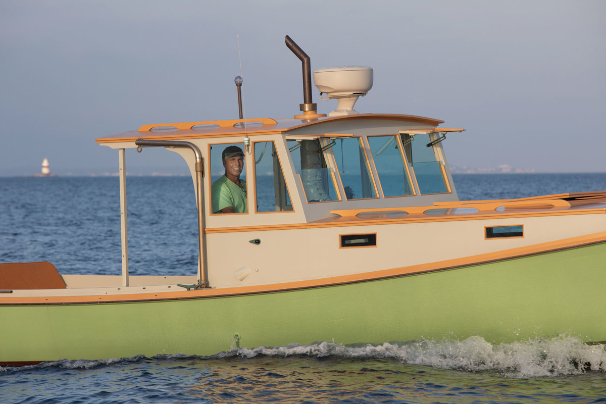 Tommy Townsend at the helm of Alice W., a lobsterboat designed and built by Vinal Beal on Beals Island, Maine