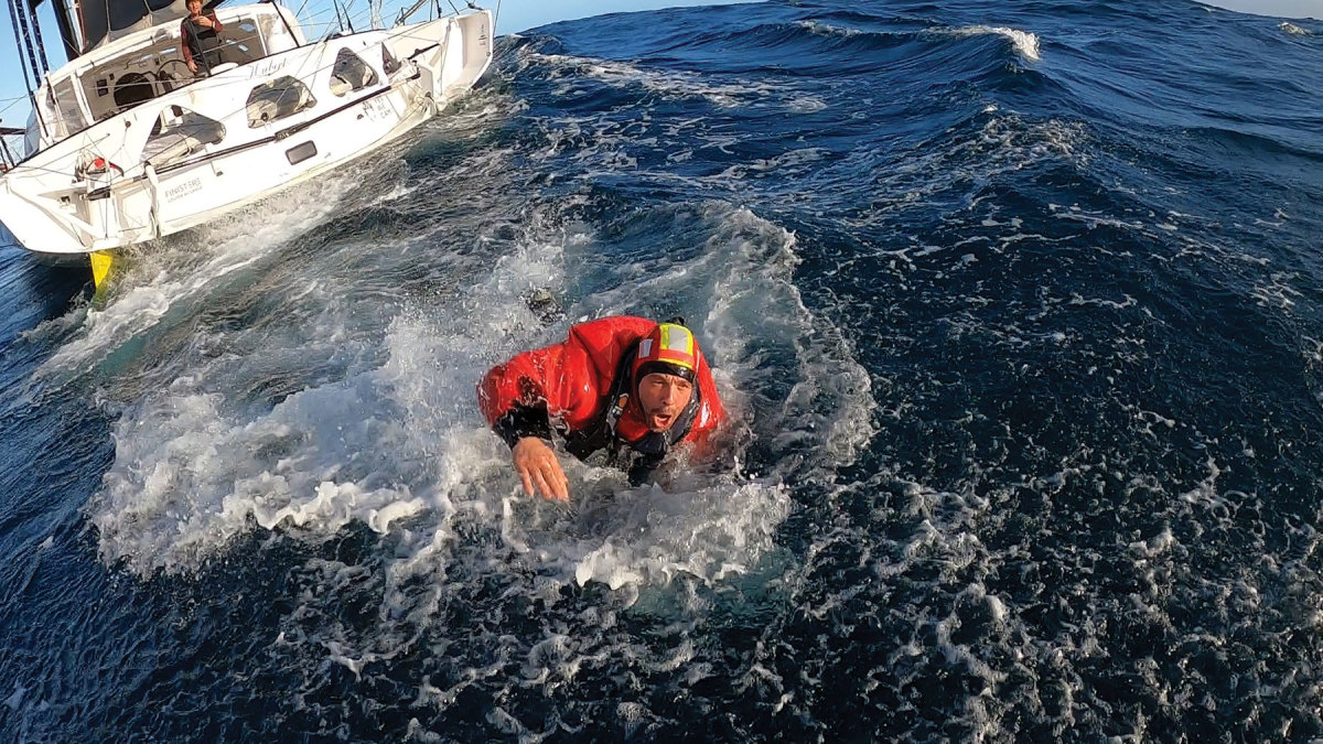 Escoffier swims toward a French Navy Zodiac so Le Cam can continue the race alone.