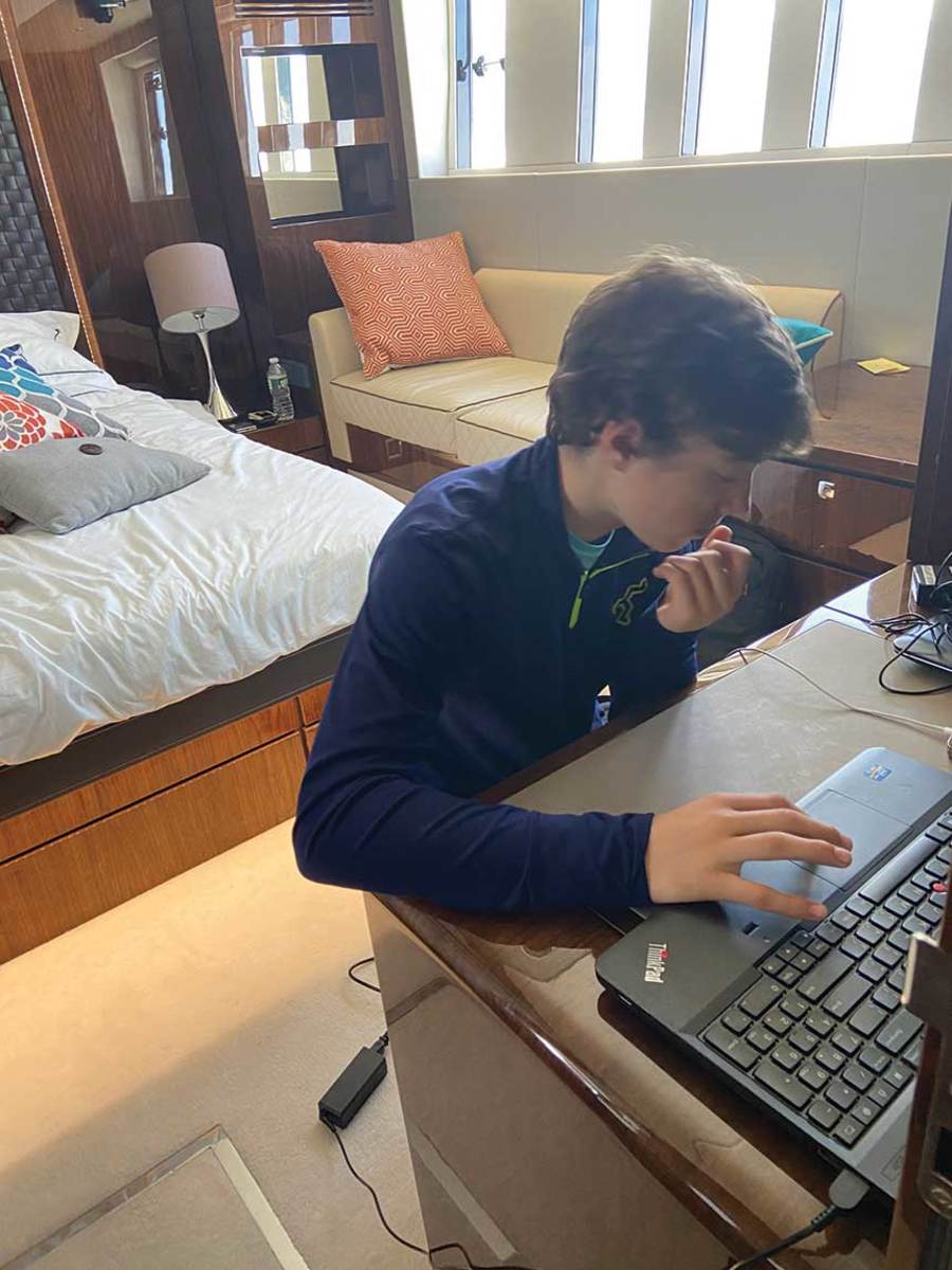Michael connects to school from the stateroom of the Fairline 65.