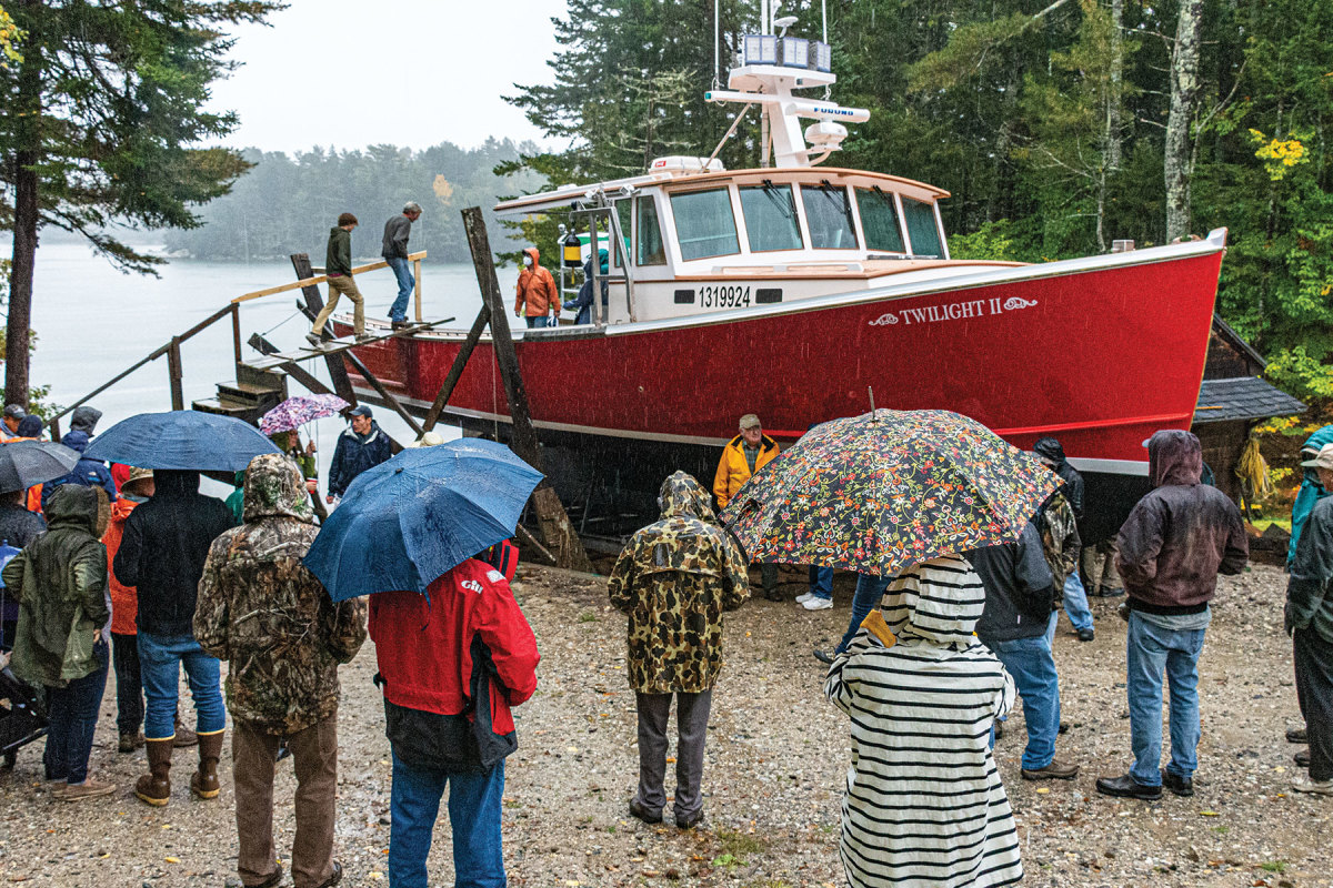 Despite torrential rain, more than a hundred people showed up to see the latest John’s Bay Boat Company design get launched. Some people drove for hours.