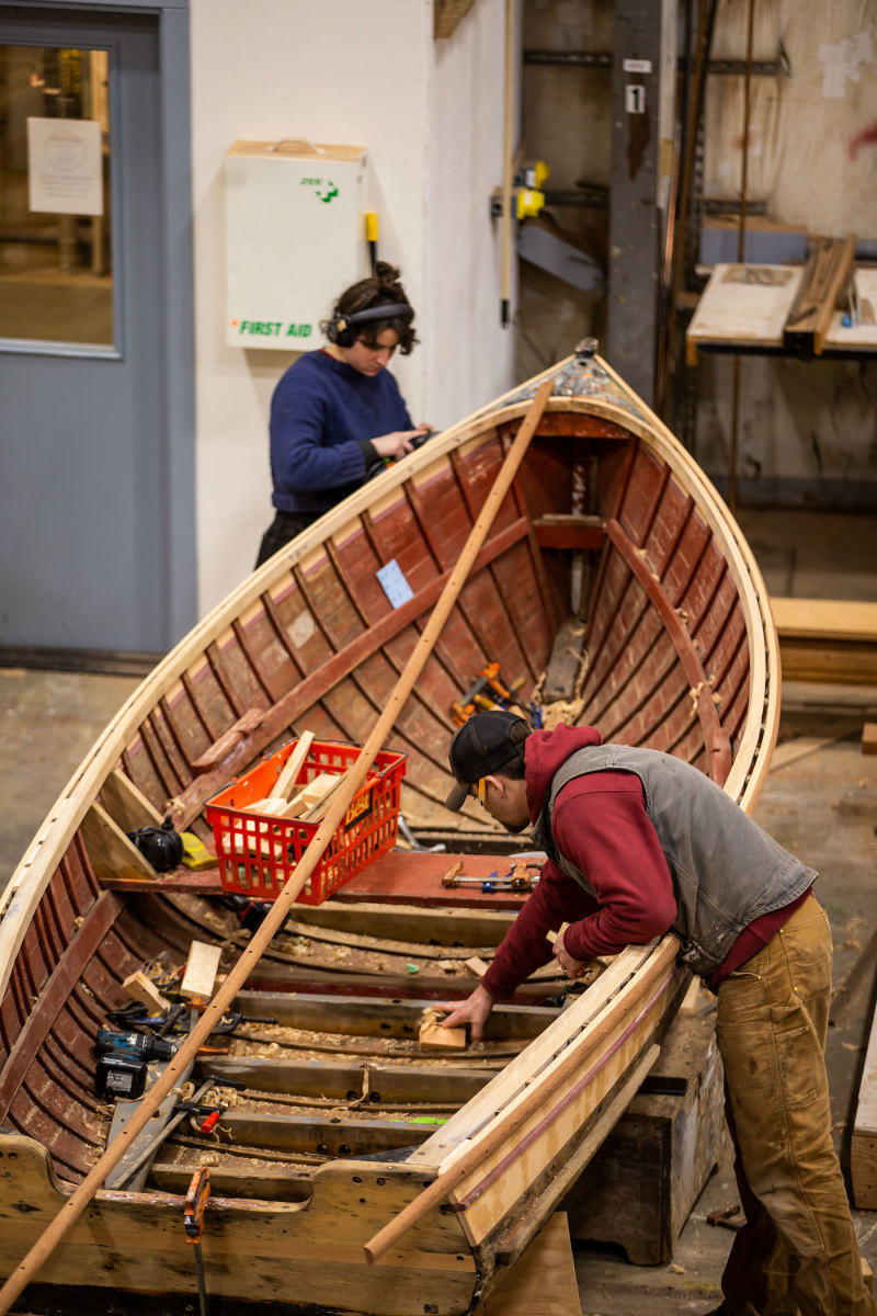 Employees restore a classic Gig Harbor skiff. 