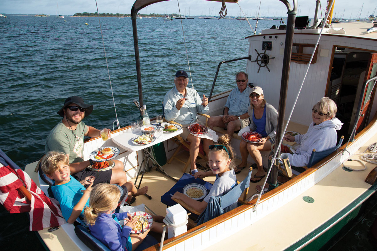 A happy crew enjoys the food delivered to their boat from Ford’s Lobster in Noank.