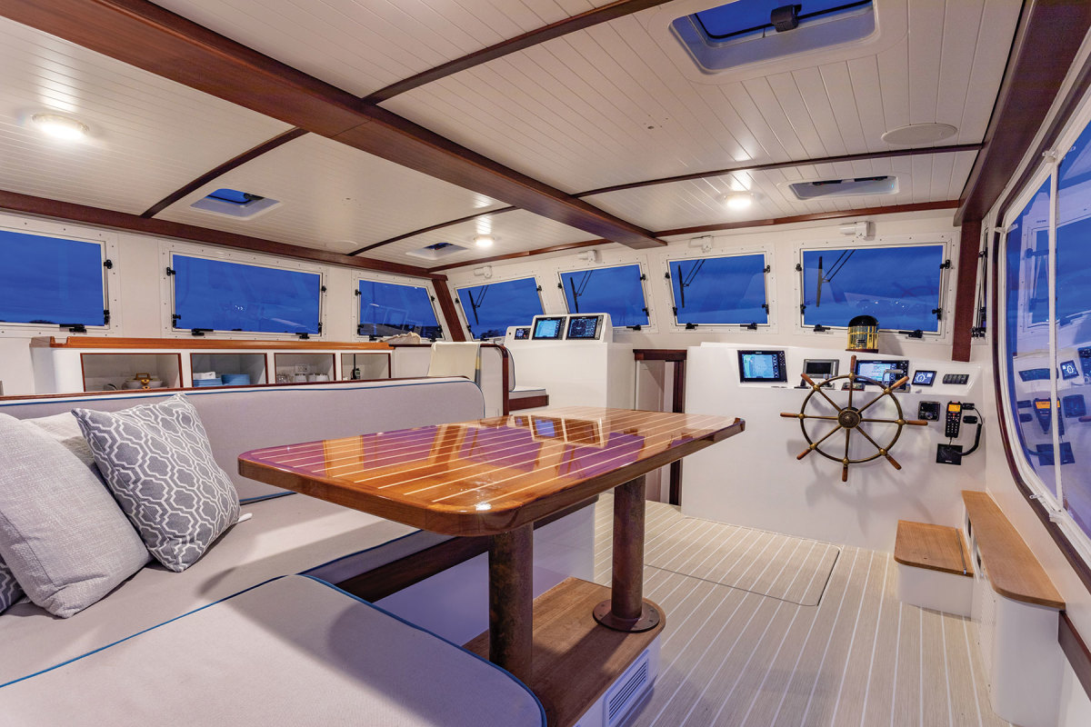 The pilothouse is designed for entertaining and livability, with an L-shaped lounge and adjacent galley located directly behind the helm.