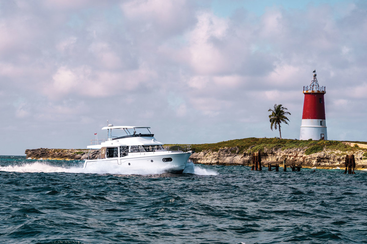 The Beneteau Swift Trawler 48 makes its way past the lighthouse at Gun Cay. 