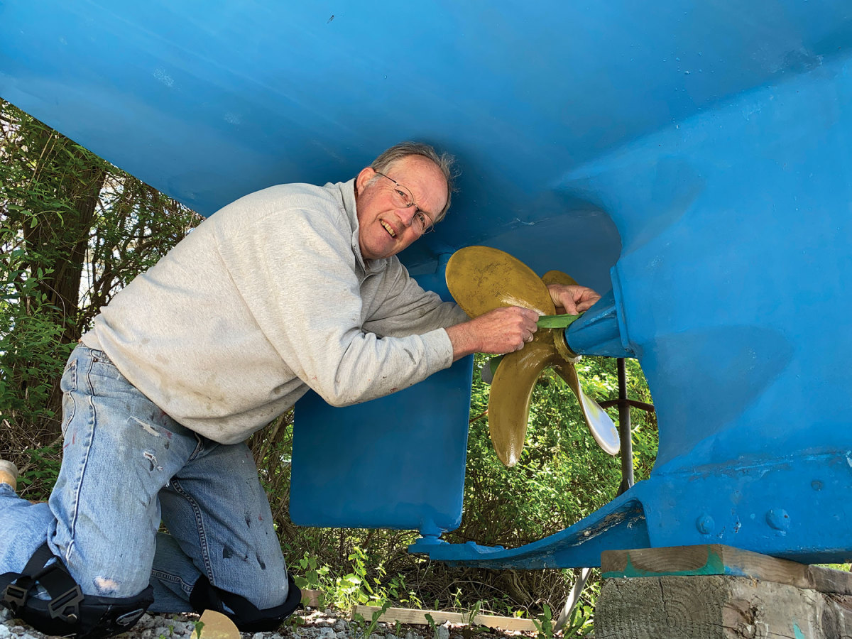 After Propspeed’s Keith Mayes applied the foul-release coating to Snow Goose’s propeller, Onne removes the green tape that protected the bottom paint. 