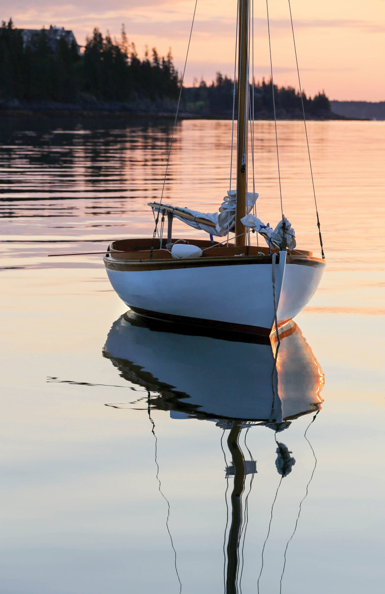 A reflection of beauty and grace, a 121/2 rests at its mooring on a calm evening.