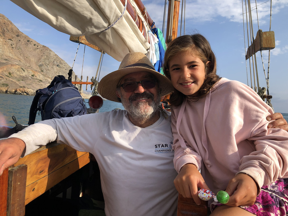 Alejandro Bugacov with his youngest daughter, Alexandra, aboard their 40-foot gaff-rigged wooden cutter 