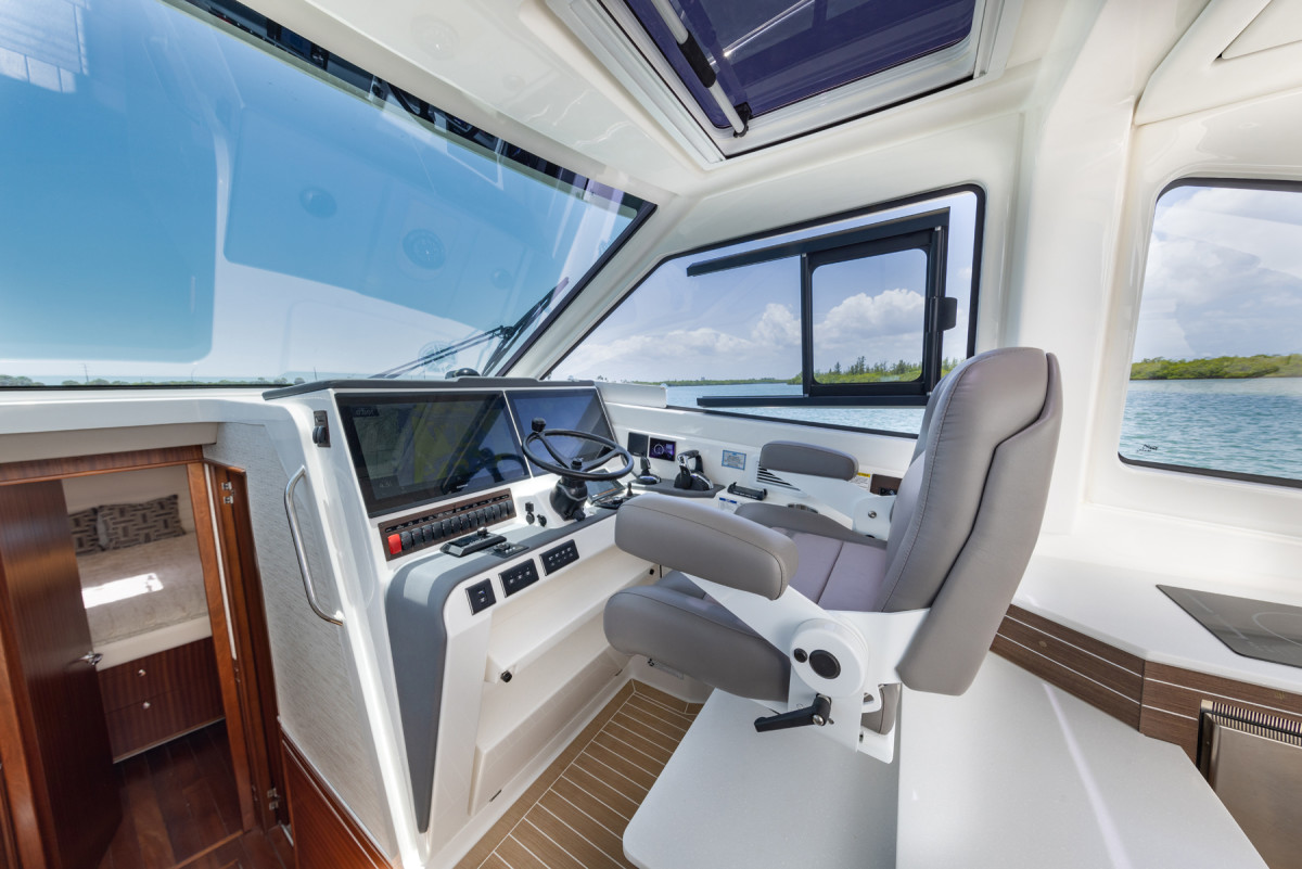 The helm features an electric Stidd chair with a multi-position footrest, great visibility and twin 22-inch Garmin MFDs.