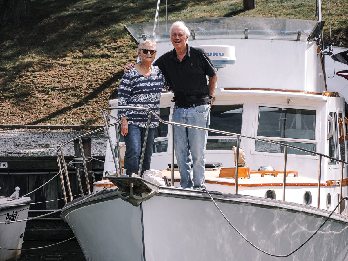 Carol and Tom Donlan stand on the bow of their Wilbur 32, Spirit.